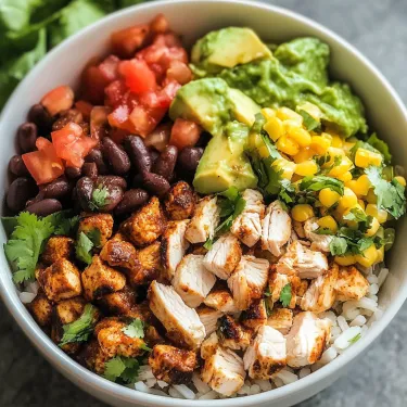 A bowl of food with rice, chicken, beans, and avocado.