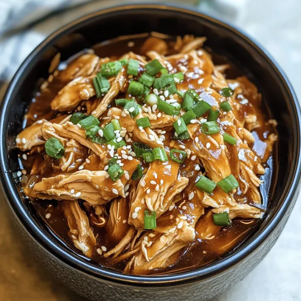 A bowl of chicken with green onions.
