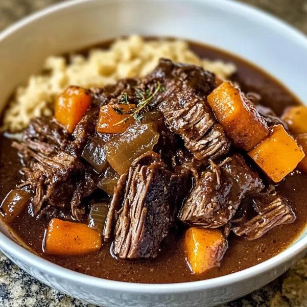 A bowl of stew with meat and vegetables.