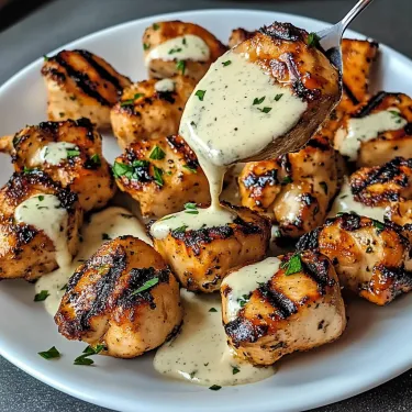 A plate of chicken with sauce.