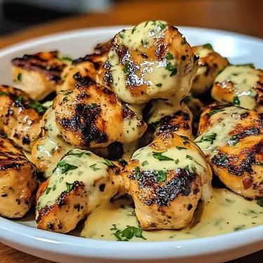 A plate of chicken with sauce.