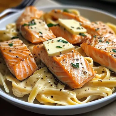 Bowl filled with pasta, salmon, and cheese shavings.