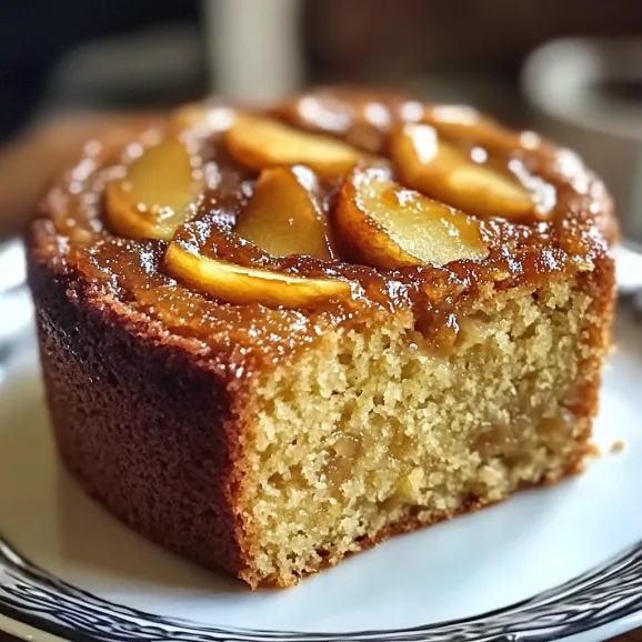 A slice of cake with apple slices layered on top.