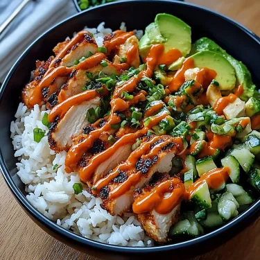 A bowl of food with rice, chicken, and avocado.