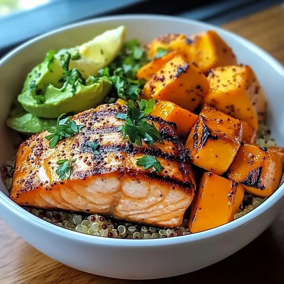 A bowl packed with veggies and grilled salmon.