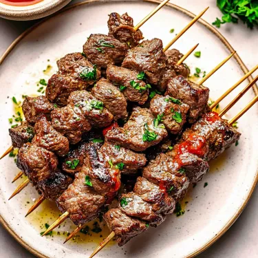 Some juicy beef on sticks, ready to eat.